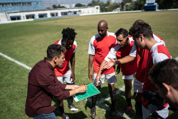 istock Coach talking to soccer players during match 1398380447