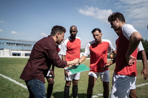 istock Coach talking to soccer players during match 1398380448