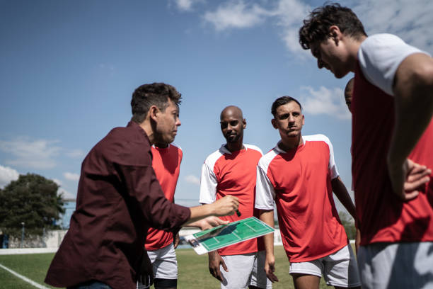 istock Coach talking to soccer players during match 1398380450