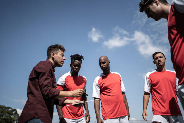 istock Coach talking to soccer players during match 1398380451