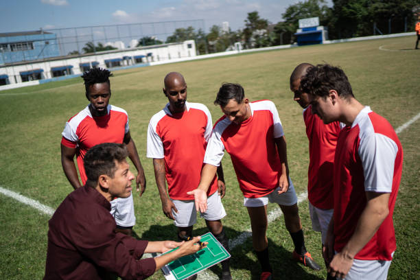 istock Coach talking to soccer players during match 1398380452