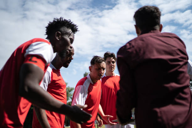 istock Coach talking to soccer players during match 1398380453
