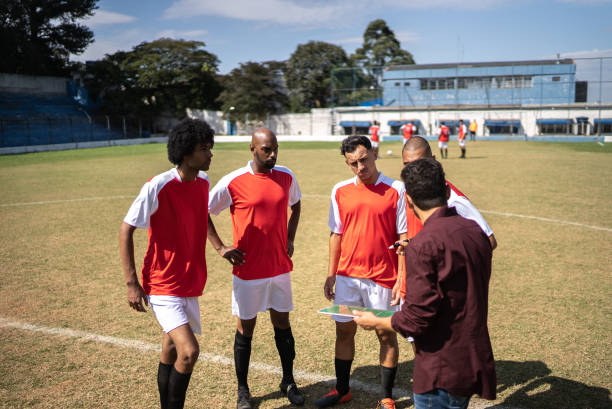 istock Coach talking to soccer players during match 1398380463