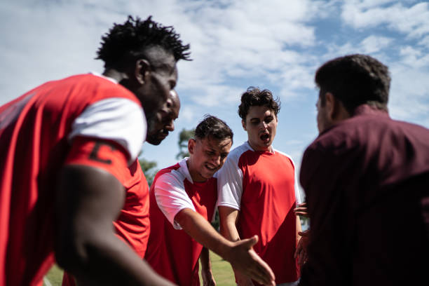istock Coach talking to soccer players during match 1398380464