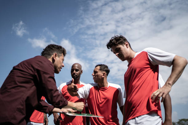 istock Coach talking to soccer players during match 1398380469