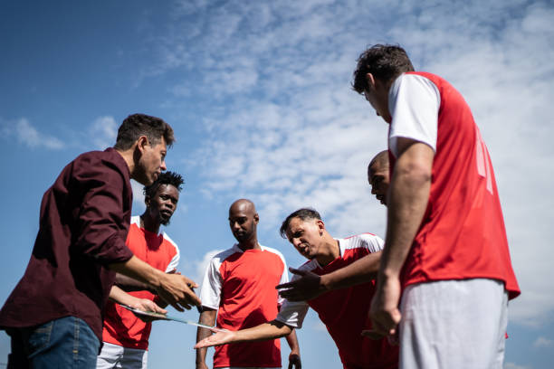 istock Coach talking to soccer players during match 1398380478