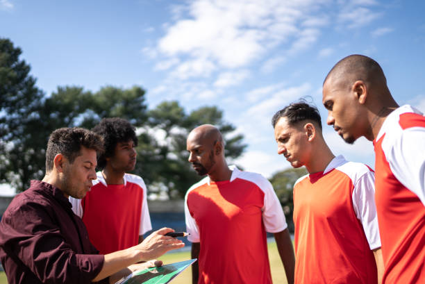 istock Coach talking to soccer players during match 1398380490