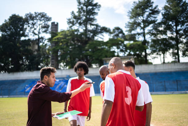 istock Coach talking to soccer players during match 1398380521