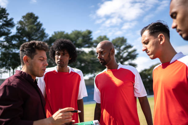 istock Coach talking to soccer players during match 1398380528
