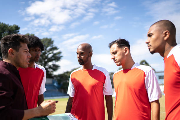 istock Coach talking to soccer players during match 1398380532