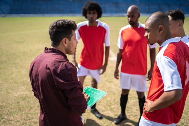 istock Coach talking to soccer players during match 1398380536