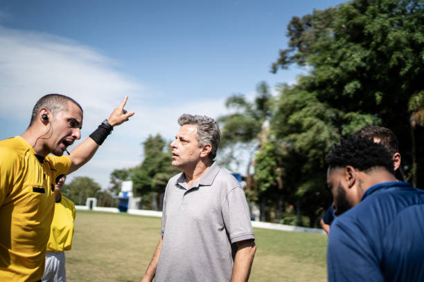istock Soccer players and coach complaining to referee during match 1398380562
