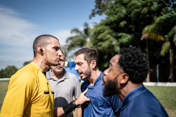 istock Soccer players and coach complaining to referee during match 1398380588