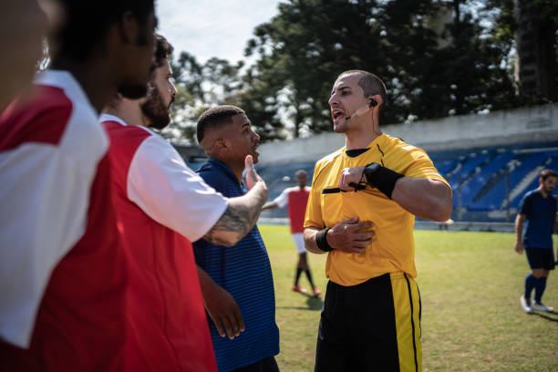 istock Soccer players complaining to referee during match 1398380608