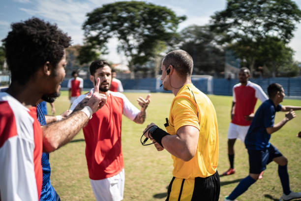 istock Soccer players complaining to referee during match 1398380668