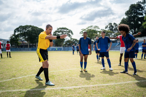 istock Referee whistling during soccer match 1398380731