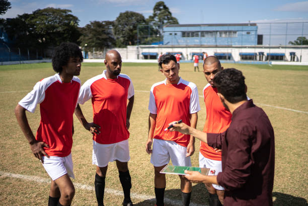 istock Coach talking to soccer players during match 1398380809