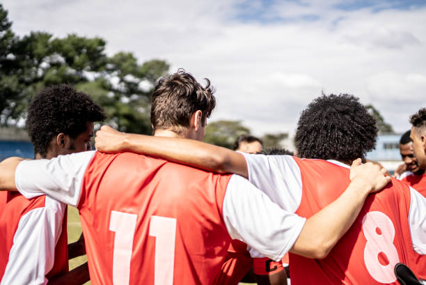 Soccer team players huddling before match starts