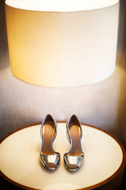 istock Silver wedding shoes on the wooden table 1398380888