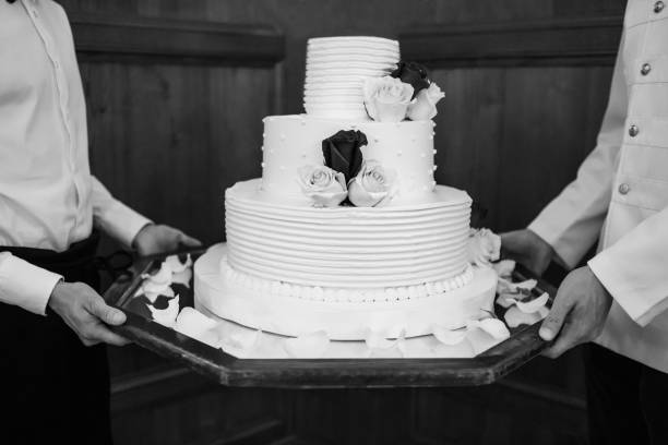 istock Multi level white wedding cake on a base and flowers on top 1398380916