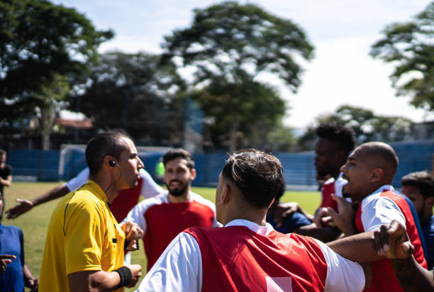 istock Soccer players complaining with referee during the match 1398380928