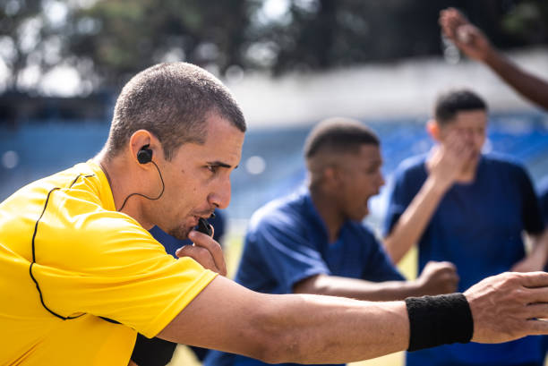 istock Referee blowing whistle and pointing a fault 1398381068