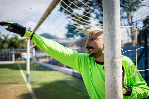 pensioner senior man with a soccer ball in a park