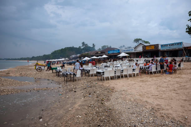 Bali, Indonesia - March 23, 2017: Patrons at a beachside restaurant in Jimbaran, Bali.