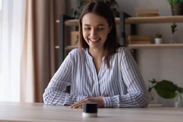 istock Happy young woman using small portable speaker 1398385360