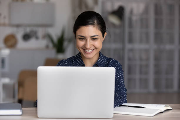 istock Happy millennial Indian girl working at laptop computer 1398385364