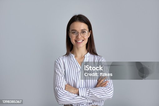 istock Happy millennial business woman in glasses posing with hands folded 1398385367