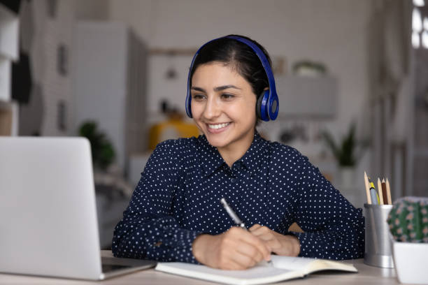 istock Happy ethnic Indian student girl watching learning media content 1398385372