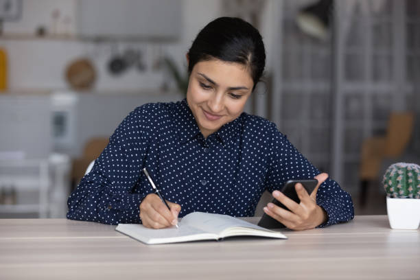 istock Focused smiling Indian employee chatting to customer 1398385374