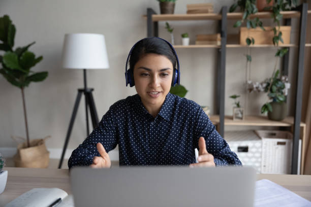 istock Serious busy Indian support center employee talking to customer 1398385391