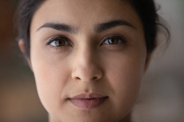 Face portrait of beautiful young Indian woman Face portrait of beautiful young Indian woman. Close up of serious ethnic 20s 30s girl with perfect skin, well shaped black eyebrows, natural makeup looking at camera. Beauty care, ethnicity concept asian eyebrows stock pictures, royalty-free photos & images