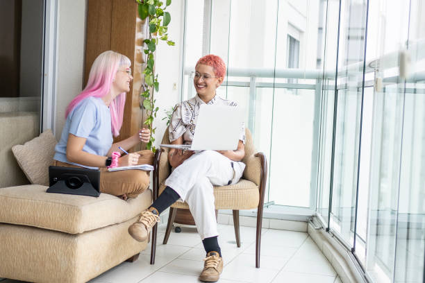 istock Lesbian couple working with laptop at home 1398385578