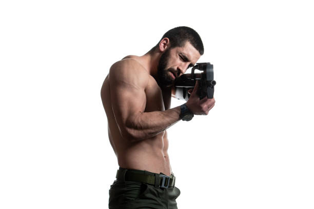 istock Bodybuilder Man Holding Gun Isolated on White Background 1398388594