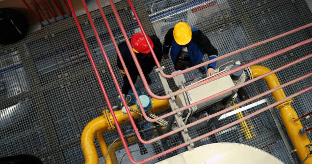 A high angle view of unrecognizable power plant workers.