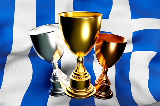 3d illustration of a cup of gold, silver and bronze winners on the background of the national flag of Greece. 3D visualization of an award for sporting achievements