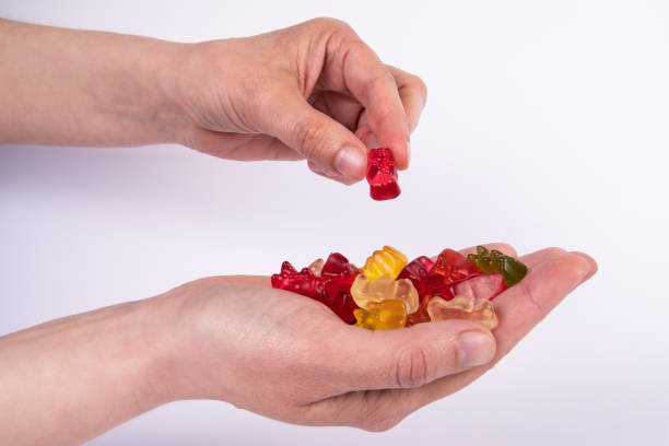 istock Gummy bears putting in the palm. Candys and sweets 1398393546