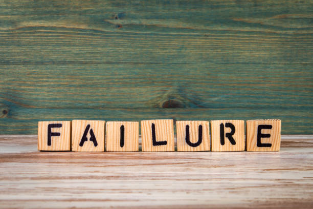 istock FAILURE. Text from wooden letters on a green and white background 1398393571