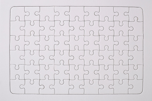 Overhead shot of blank white jigsaw puzzle texture background