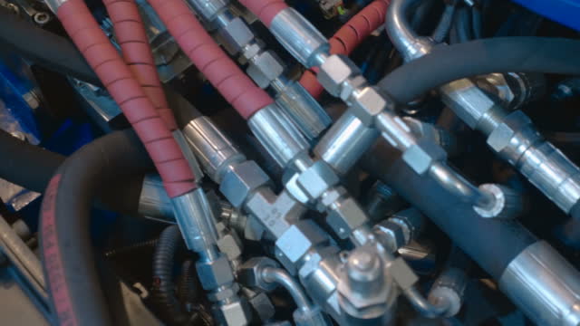 A unit of industrial equipment where the accumulation of hydraulic hoses