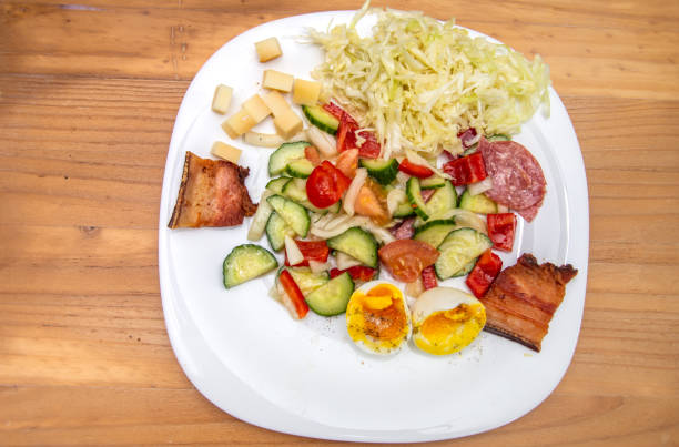 istock cold appetizer with boiled eggs, cucumber, salami, tomatoes and cheese 1398402482
