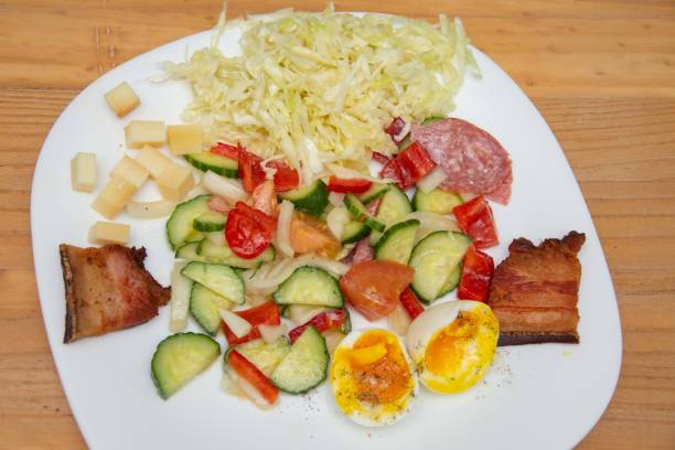 istock cold appetizer with boiled eggs, cucumber, salami, tomatoes and cheese 1398402496