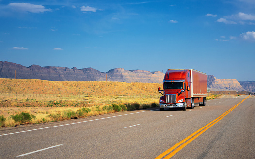 Red semi-truck speeding in Utah - panning motion blur