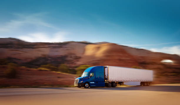 istock Refrigerated semi trailer transporting commercial cargo - panning motion blur, USA 1398404048