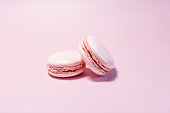 Macaroons of pink color close-up on a light pink background.