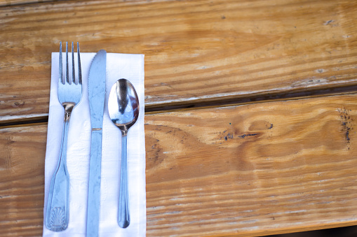Paper Napkin and Single Place Setting Silverware on Picnic Table