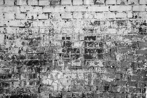 Brick wall painted with paint surface for background. Brick wall. Close-up. Old wall